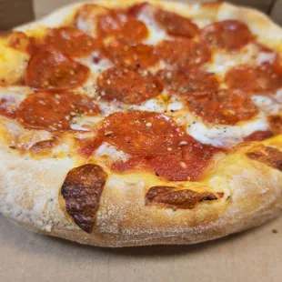 a pepperoni pizza in a box