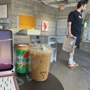 a laptop and iced coffee on a table