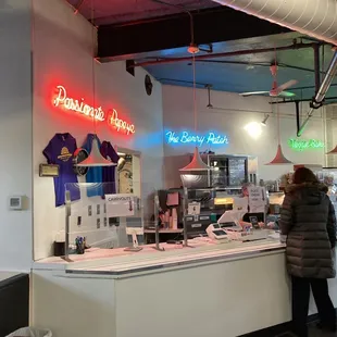 a couple of people standing in front of a counter