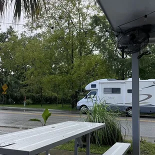 a picnic table and a motorhome in the rain