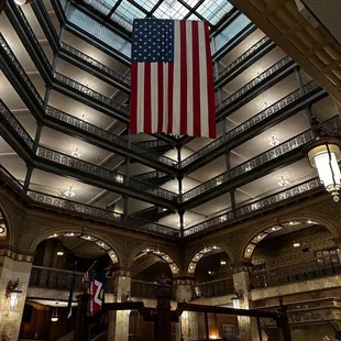 a large american flag hanging from the ceiling