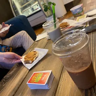 a person eating a sandwich and a drink