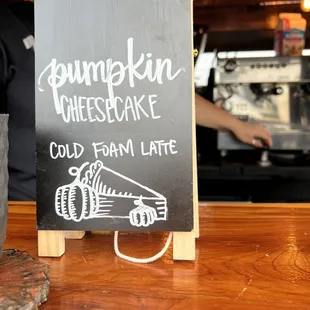 a chalkboard sign for a coffee shop