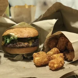 burgers and tater tots in paper bags