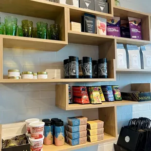Chocolate, French press, glass cups, ground coffee, and snacks for purchase