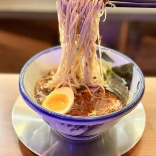 a bowl of ramen with chopsticks