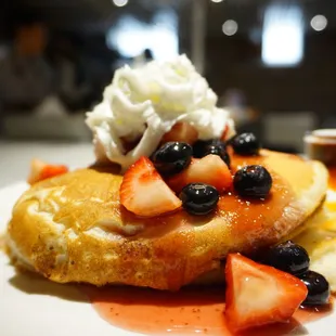 a plate of food with fruit and whipped cream