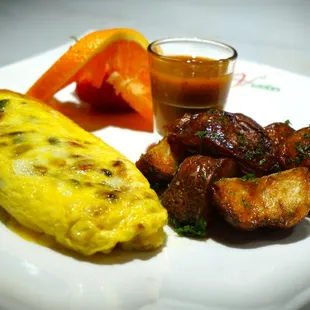 an omelet, potatoes, and carrots