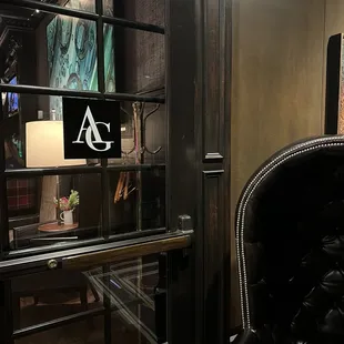 a black leather chair in front of a glass door