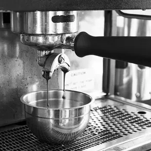 a coffee maker making a cup of coffee