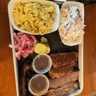 a tray of meat and sides