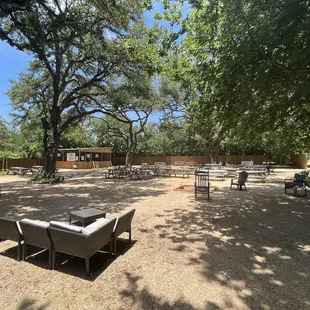 Huge back picnic dining area with a stage for live music and a caged area for ax throwing