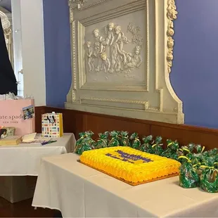 a table with a yellow cake on it