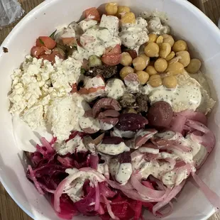 a white bowl of food on a wooden table