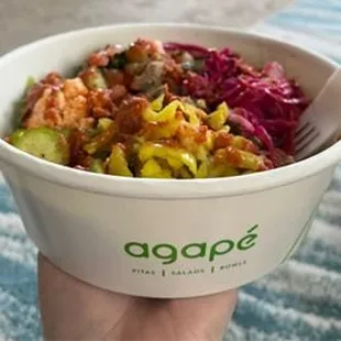 a person holding a bowl of food