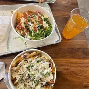 two bowls of pasta and a glass of orange juice