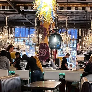 people sitting at tables in a restaurant