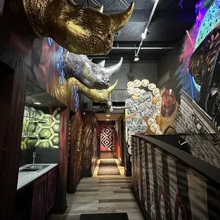 a hallway with a mural of a rhino