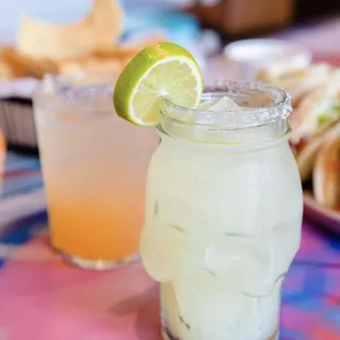 a close up of a margarita with a slice of lime