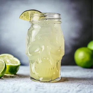 a glass of lemonade with a lime wedge