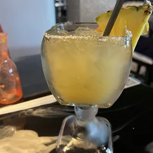a margarita with a pineapple garnish