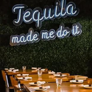 a restaurant with a neon sign that says tequila made me do it