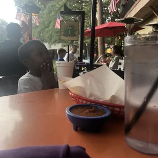 a man sitting at a table with a bowl of food in front of him