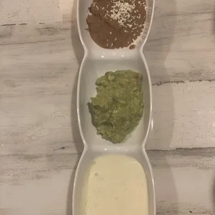 Refried beans, queso , guacamole dip.