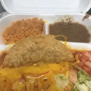 Mexican plate, taco fell apart since it was sitting in the enchilada sauce.