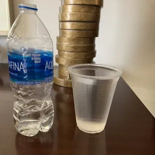 a water bottle and a shot glass