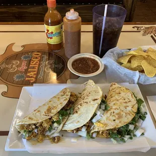 Chorizo and egg taquitos (tacos) with onions, cilantro and queso blanco