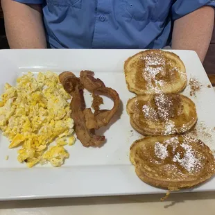 Two eggs scrambled with bacon and pancakes