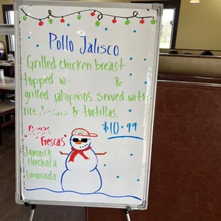 a white board with a snowman drawn on it
