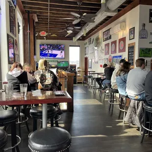 people sitting at tables in a restaurant