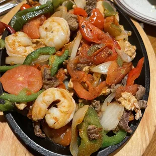 Steak, chicken and shrimp fajitas!  Delicious