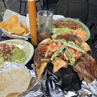 Special #1 Prime rib, chicken, shrimp, chorizo, cojita, peppers, beans, rice, gauc, pico. All in a cute, hot stone pig bowl.