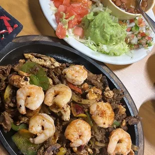 Parriada Plate Which is pretty much a Fajita Plate with Shrimp,Chicken and Steak with bell pepper and onion.