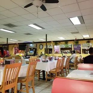 a dining area with tables and chairs