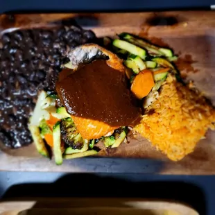 Salmon with mole, black beans and rice