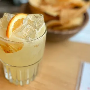 a glass of lemonade with a slice of orange