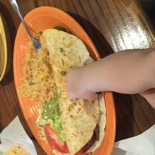 Enormous, delicious veggie quesadilla. Baby hand for scale