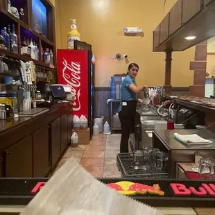 a woman preparing food in a restaurant kitchen