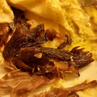 Shoe leather beef throughout both burritos.  Left half on the plate for the trash pandas.