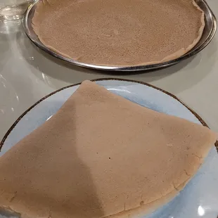 Injera bread... the center one is the one you dunk the gravy on and eat family style