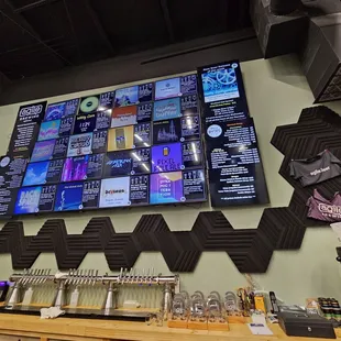 a wall of beer taps and a television