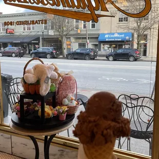 an ice cream cone in front of a window