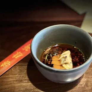 a bowl of soup and a spoon on a table
