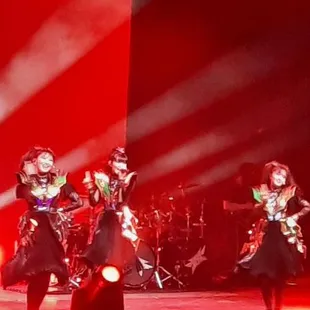 a group of dancers performing on stage