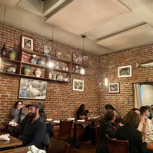 Loving the brick walls, artwork and beautiful vases on the wall!