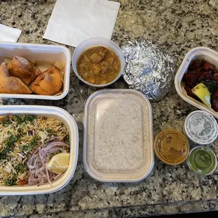 Vegetable biryani, samosas, aloo korma, garlic naan, chicken 65